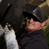 male student wearing welding protective gear